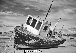 Working boat.....a small fishing boat on the sands at Lyt... by Nick Blake 